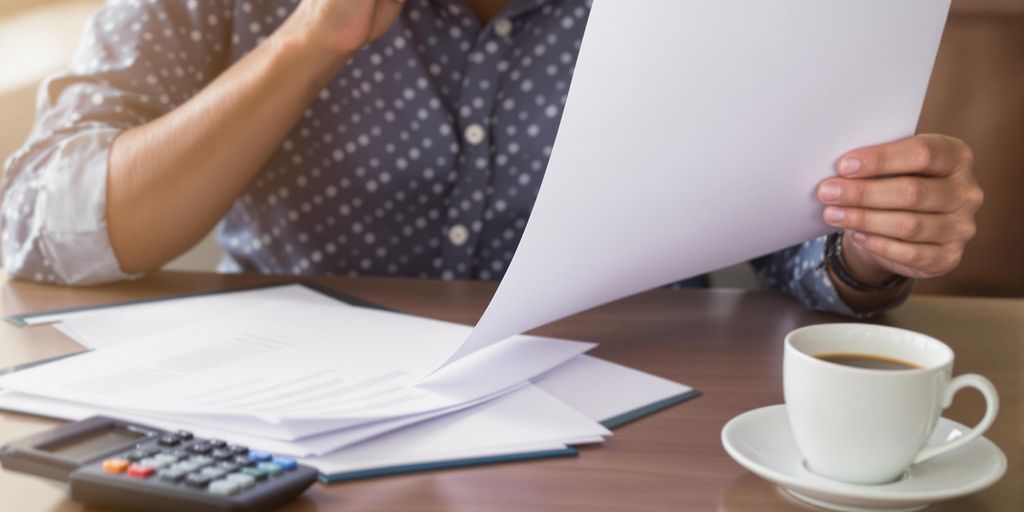 Individual reviewing disability back pay documents at a desk.